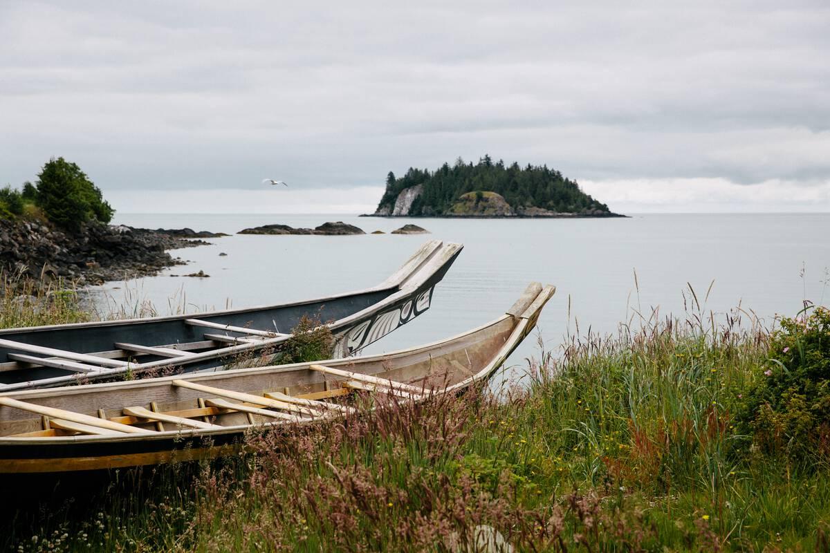 Haida canoes on the shoreline in front of the Haida Heritage Centre
