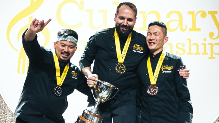 The Canadian Culinary Championship 2024 medalists pose on the podium with their medals and trophies.